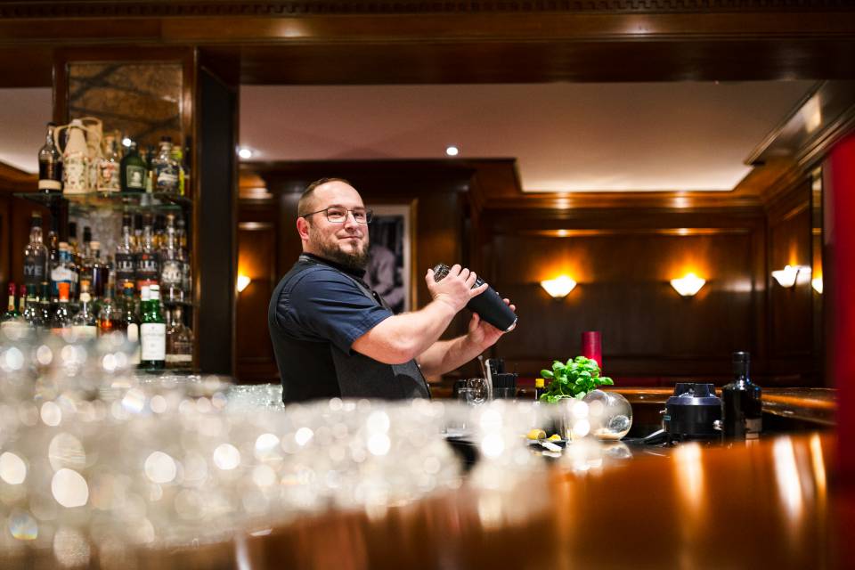 Bartender mixes a drink at the bar